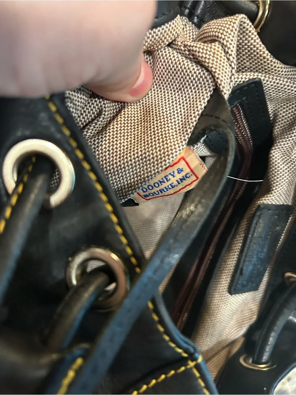 Dooney & Bourke Black Leather Drawstring Backpack with Yellow Stitching
